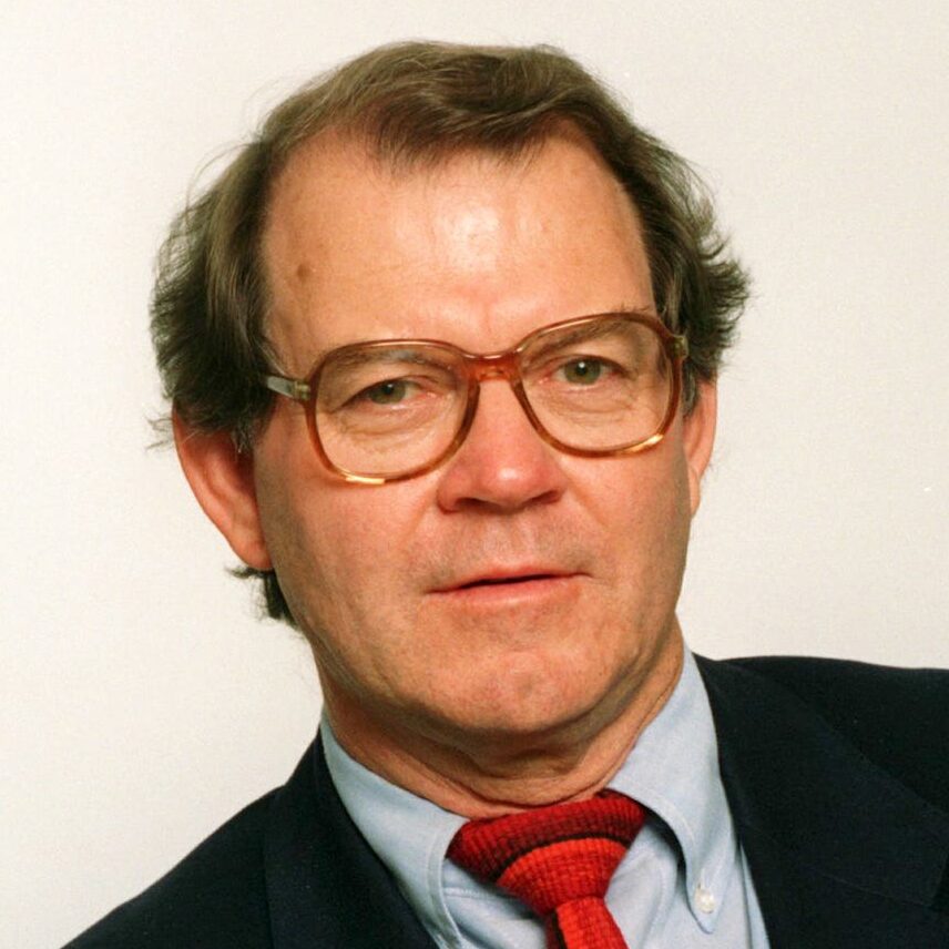 Journalist Remer Tyson wearing a dark suit and a red tie on Aug. 26, 1993