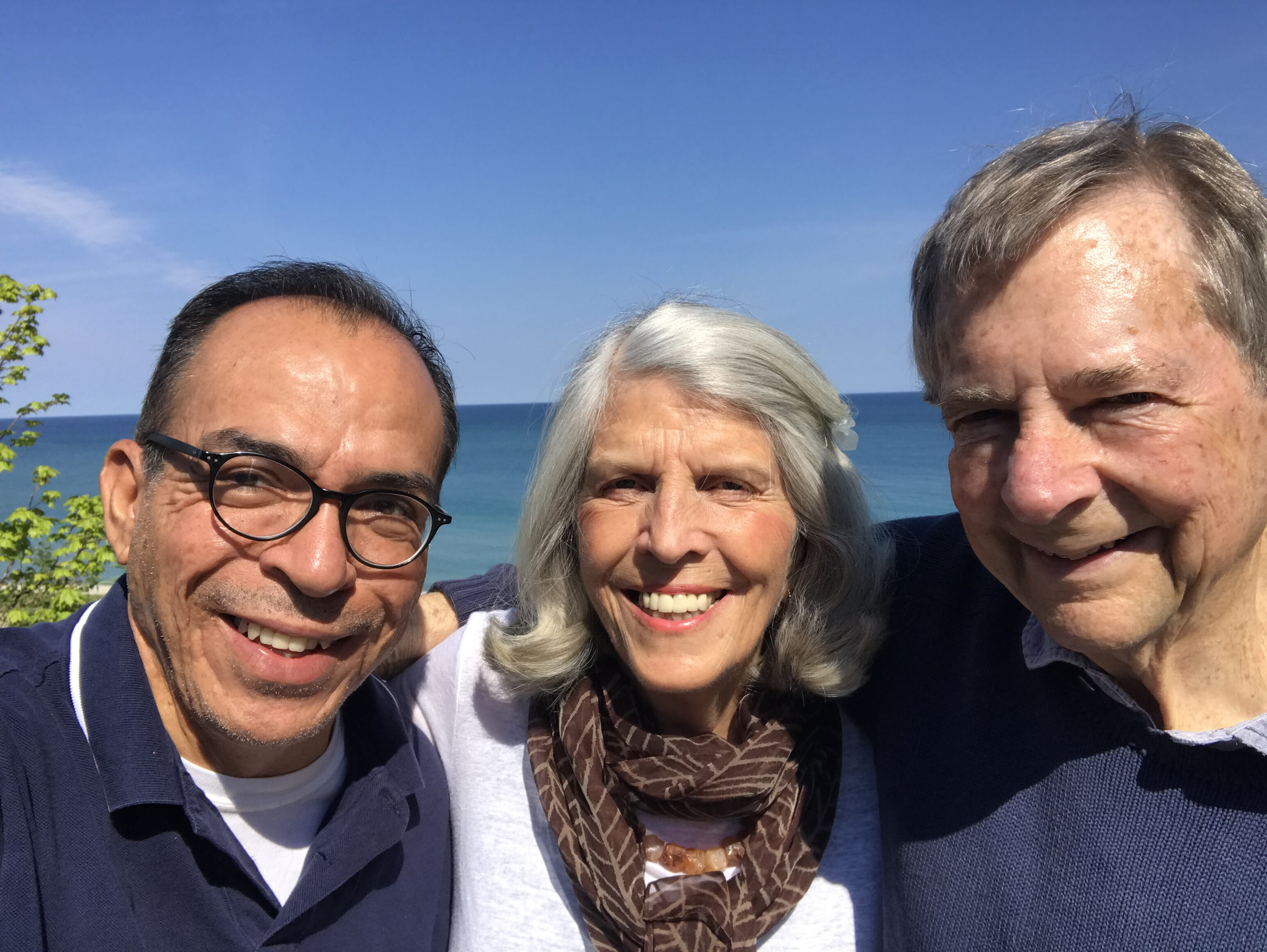 Three people at a lake