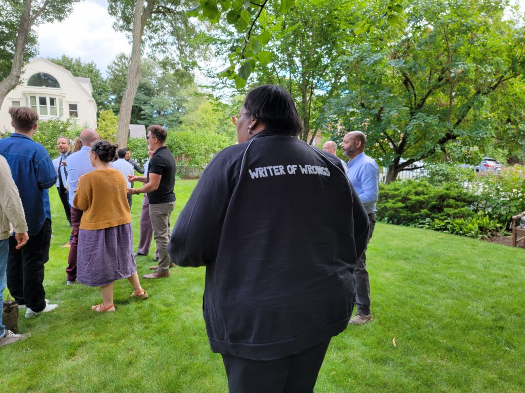 Nieman Fellow Darcel Rockett wears a jacket with the words "Writer of Wrongs" displayed on the back during orientation in August 2024.