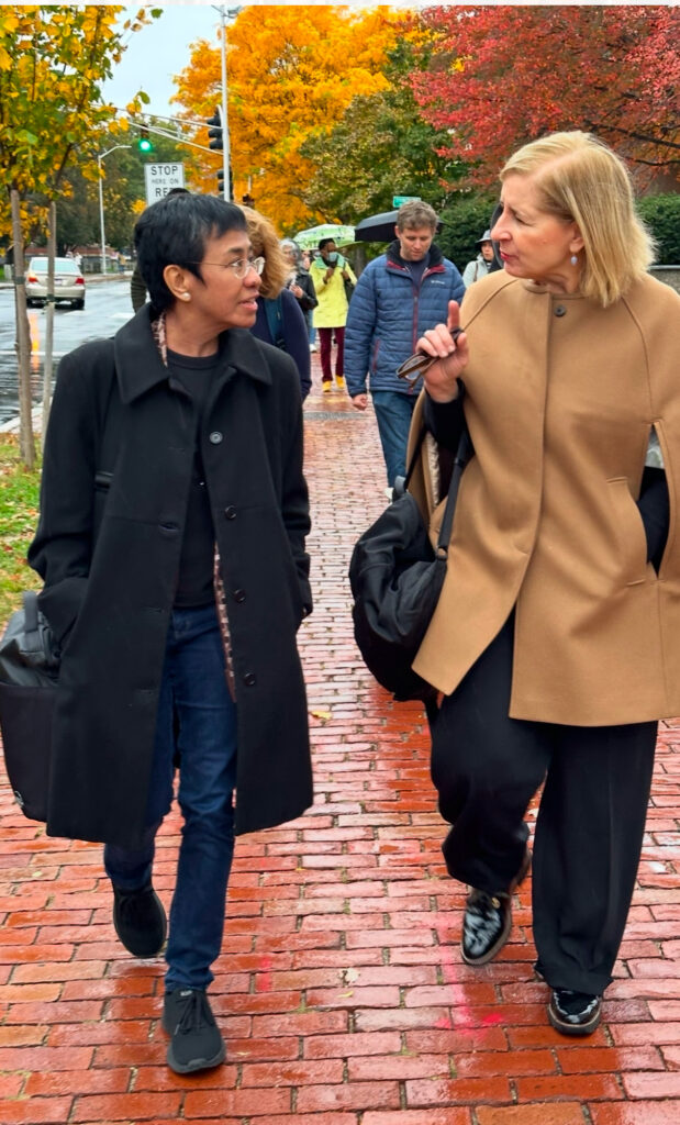 Journalists Maria Ressa and Ann Marie Lipinski walk together on the Harvard campus on Oct. 29, 2023.