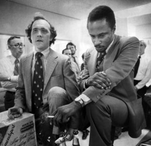 Philadelphia Inquirer reporters Wendell Rawls (left) and Acel Moore celebrate their Pulitzer Prize during the announcement in the newsroom on April 22, 1977.