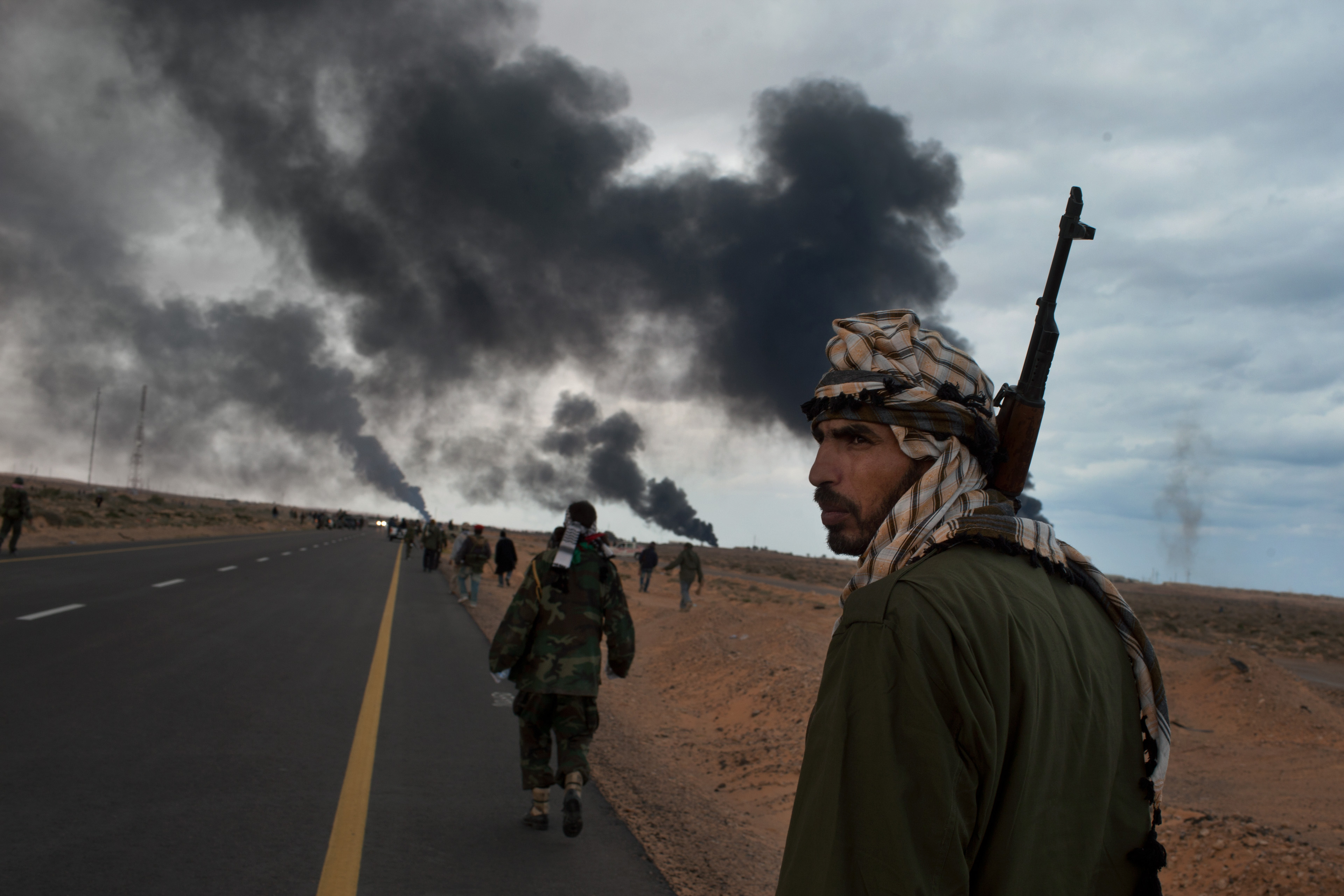 Covering war has always been dangerous but in the chaos of Libya it became riskier. Here, a natural gas facility burns in 2011 as opposition fighters push on