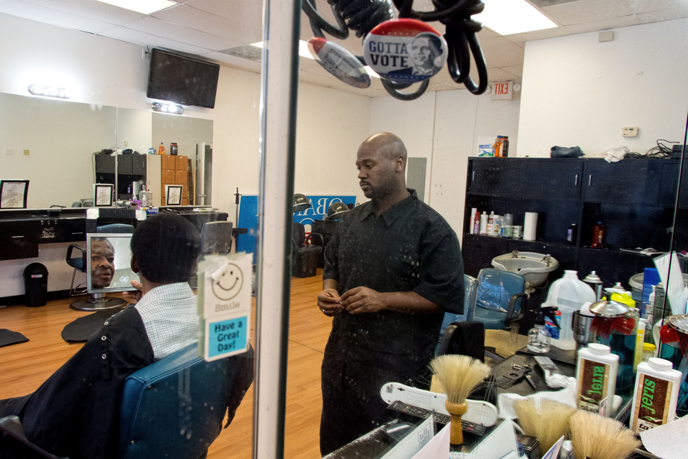 St. Louis area barber Christopher Williams with a customer whose hair he has been cutting for 14 years
