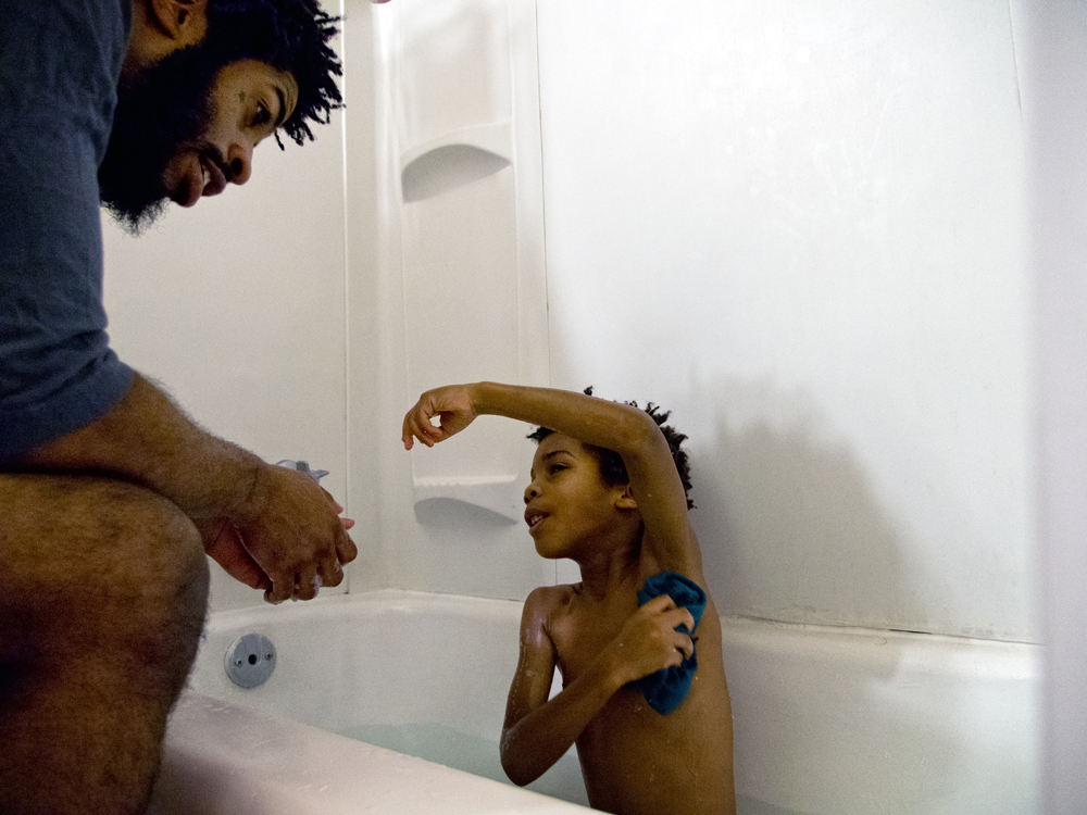 Terence Mason of St. Louis, Missouri supervises bath time for his son Kai