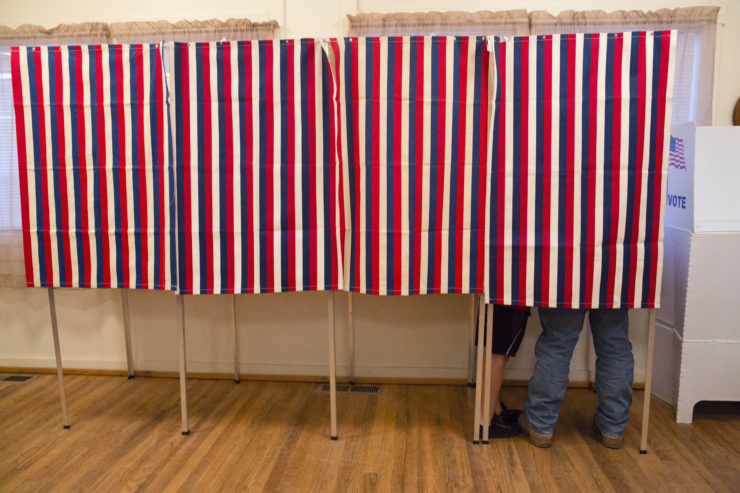 A voter fills out his ballot on Election Day at the Wilson School House in unincorporated Wilson, Idaho