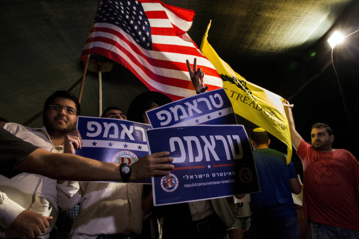 Israelis in Jerusalem hold signs reading “Trump, the Israeli interest” at an October rally sponsored by a local organization that encourages American expatriates to cast absentee ballots for Trump