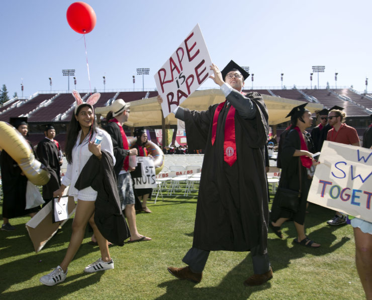 At Stanford University's commencement exercises in June 2016, a student carries a sign commenting on a recent  high-profile rape case at the school