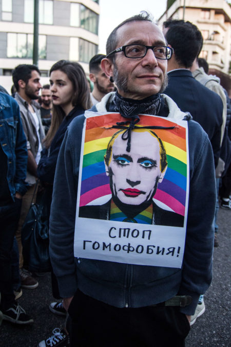 A man wears a sign with face of Vladimir Putin during a protest against homosexual extermination in Chechnya in front of the Russian Embassy in Madrid. Novaya Gazeta’s Elena Milashina broke the news of an orchestrated campaign of anti-gay repression in Chechnya
