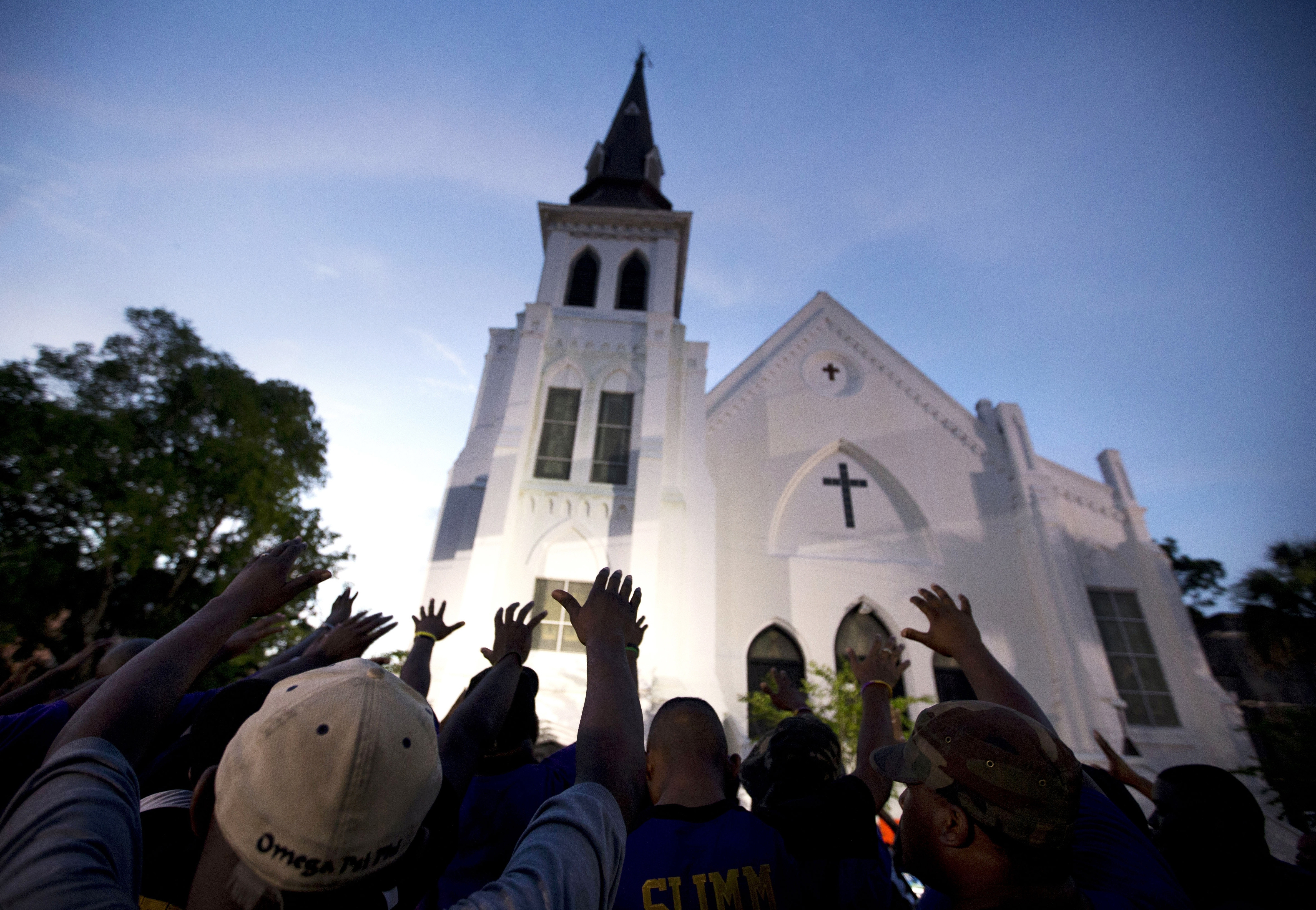 
A crowd prays outside of the Emanuel AME Church in Charleston, South Carolina after a memorial service for the nine people killed by white supremacist Dylann Roof. The Post and Courier’s newsroom discussions about the implications of implicit bias likely played a role in their coverage decisions about the mass shooting