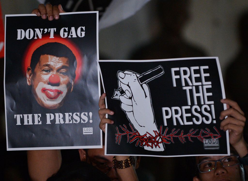 Journalists and supporters display signs, including one depicting President Rodrigo Duterte as a clown, during a protest advocating freedom of the press in Manila, the Philippines in January 2018