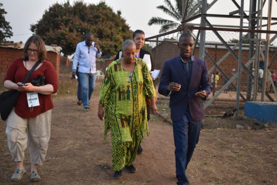 Kelley Benham French and Wanda Tucker touring an Angola village with Custodio Armando, a province official