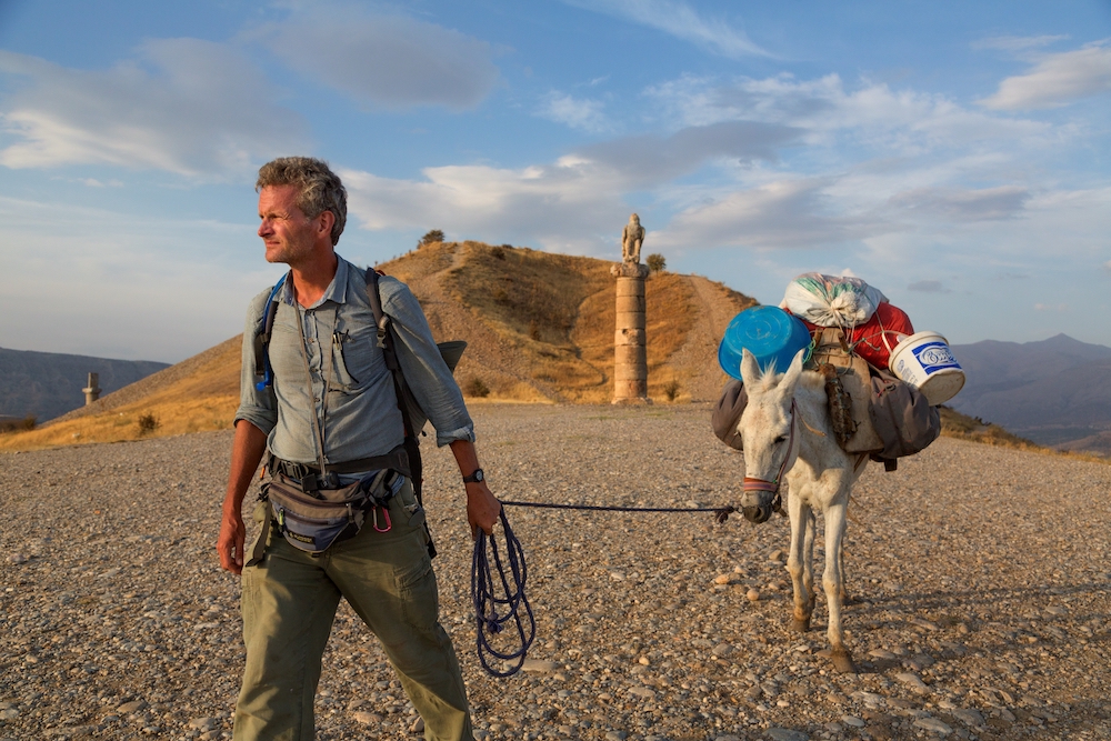 Paul Salopek, a former foreign correspondent for the Chicago Tribune, leads his mule past the Karakus royal tomb.
