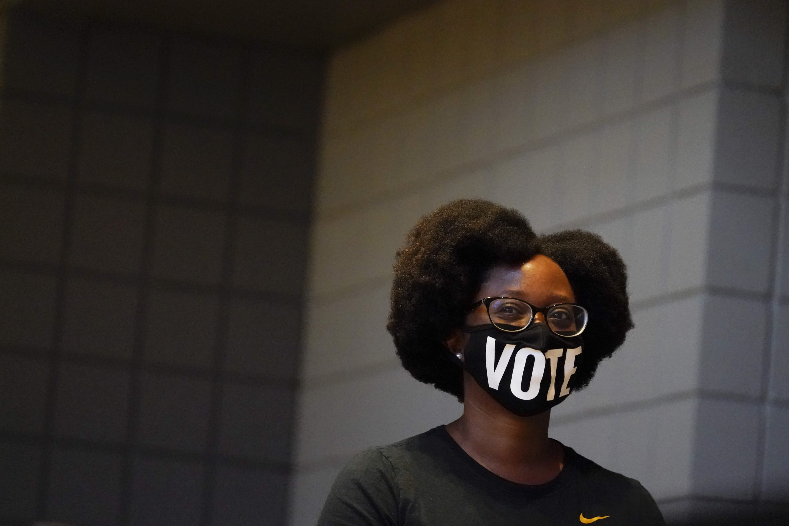 Ashley Nealy, of Atlanta waits in a line to vote early at the State Farm Arena in Atlanta in Oct. 2020. Errin Haines of The 19th* notes that Black women vote at higher rates because they understand the stakes
