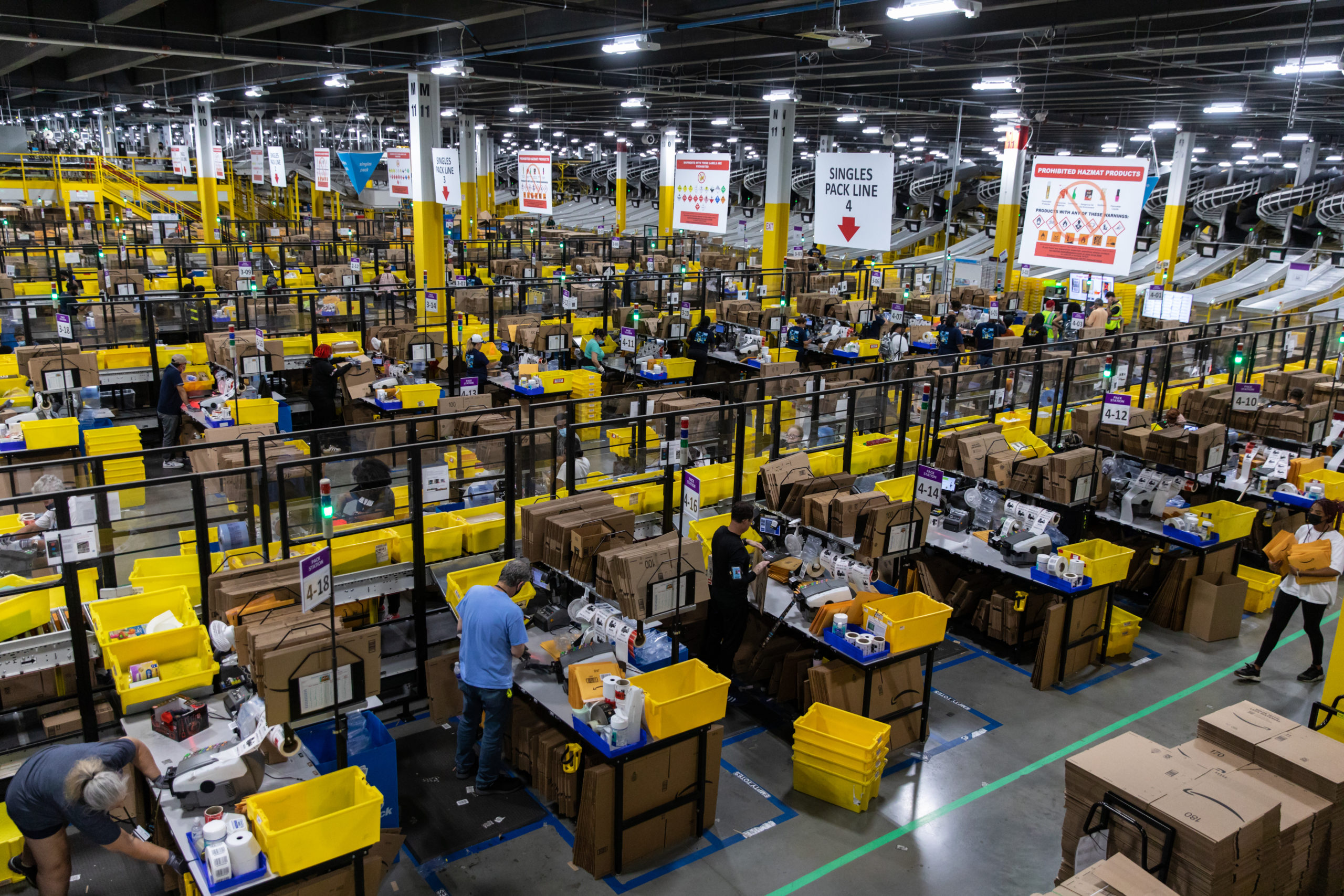 Workers fulfill orders at an Amazon fulfillment center on Prime Day in Raleigh, North Carolina in June 2021