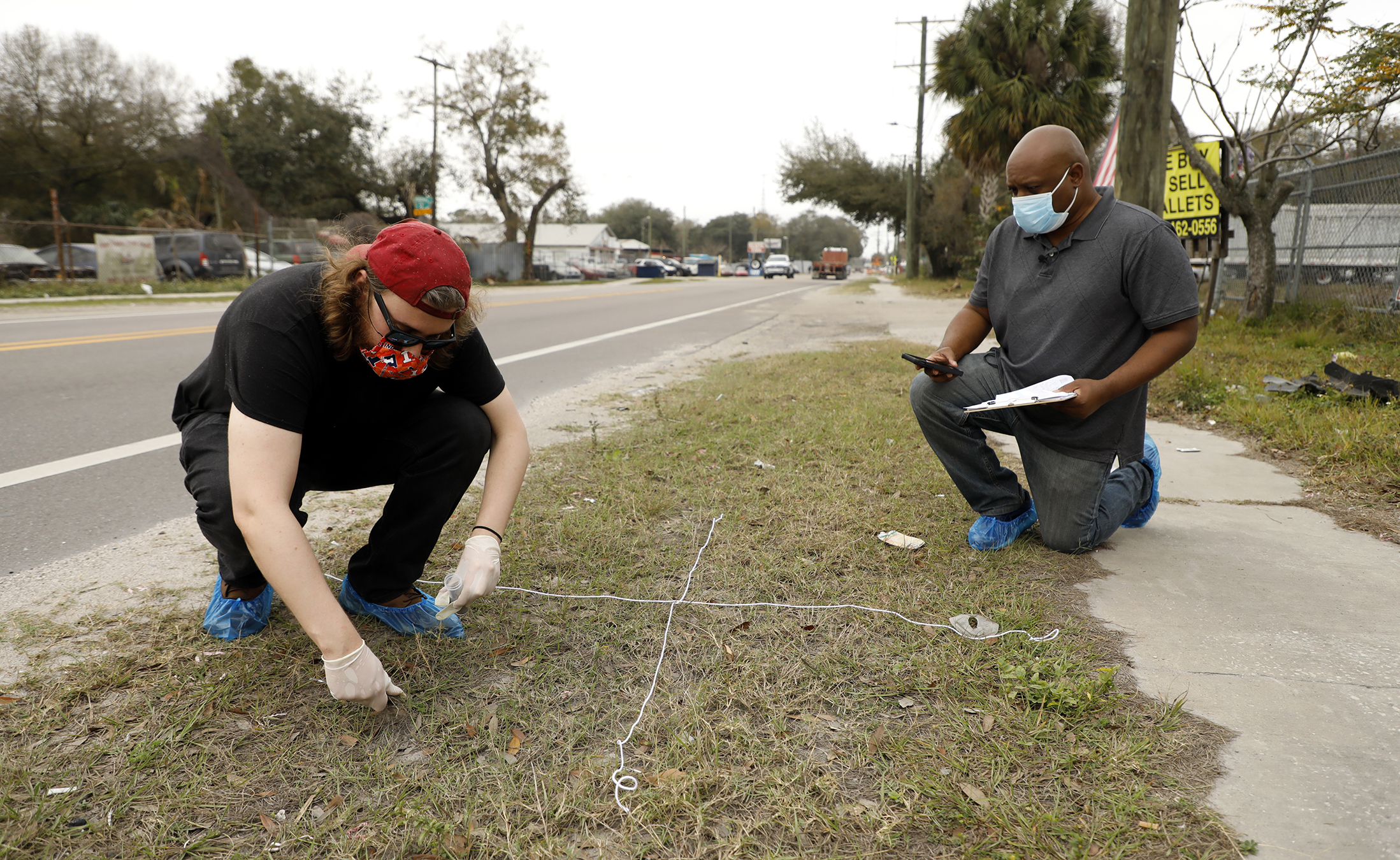 Tampa Bay Times reporters Eli Murray and Corey Johnson take soil samples near the Gopher Resource factory in Tampa, the only lead smelter in Florida.