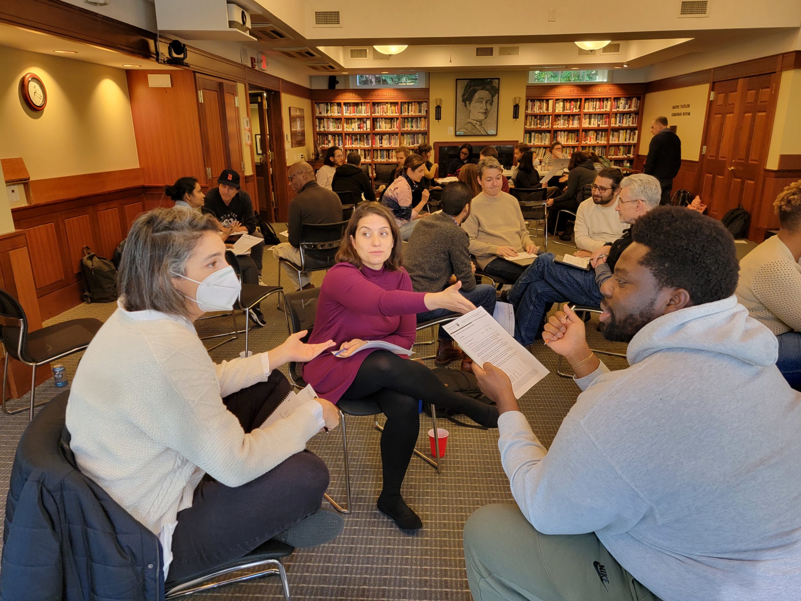 From left, 2023 Nieman Fellows Romy Neumark, Pinar Ersoy and Dotun Akintoye participate in Prof. Brian Mandell's negotiation workshop on Nov. 18, 2022.