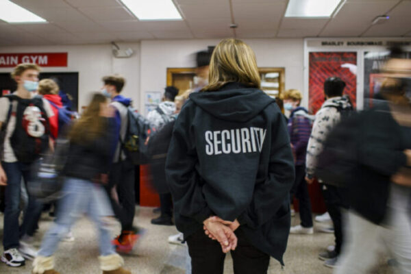 Anita Kanzaki, a member of the Bradley-Bourbonnais Community High School security staff, watches students walk between classes in January 2022.