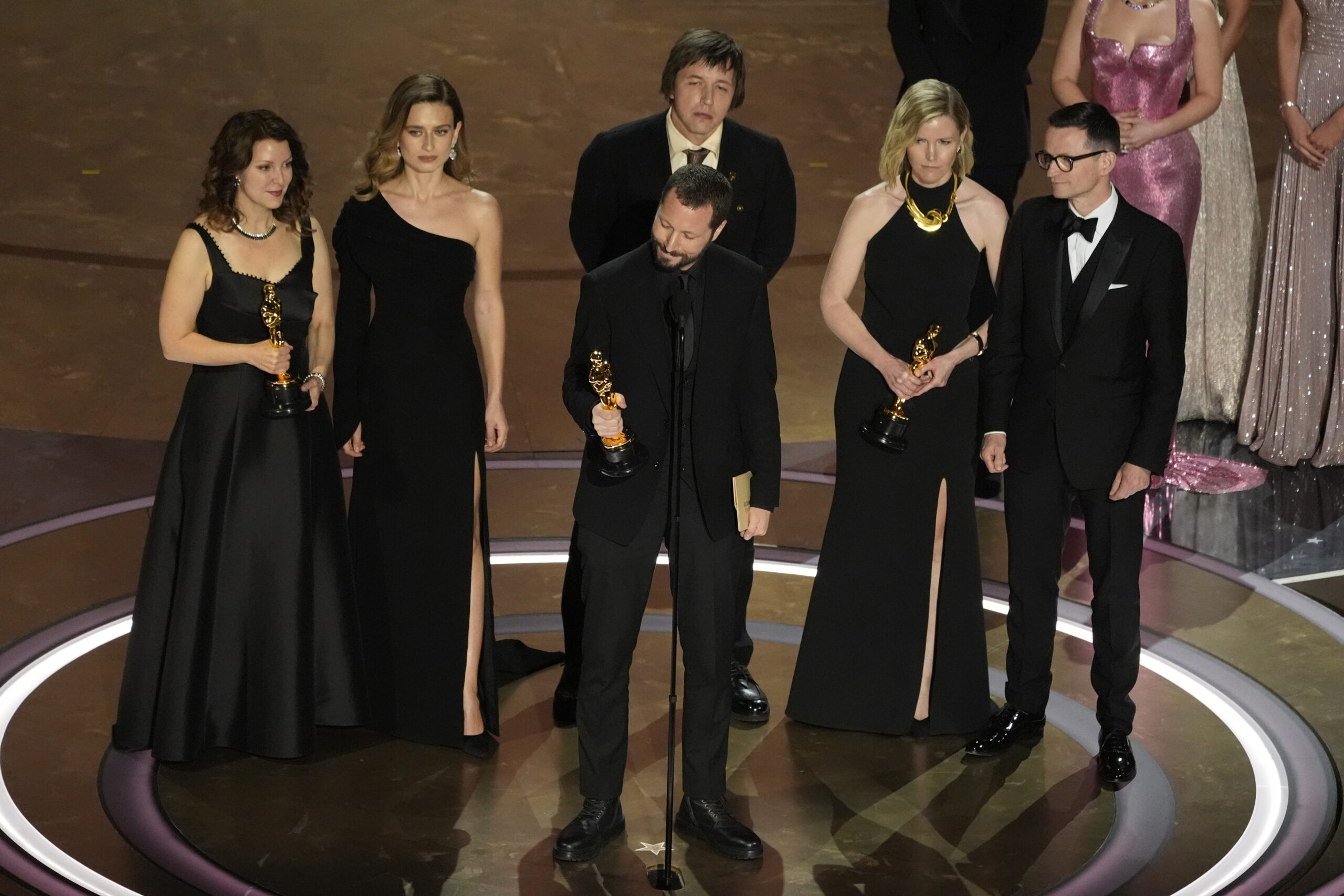 Raney Aronson-Rath, from left, Vasilisa Stepanenko, Mstyslav Chernov, Evgeniy Maloletka, Michelle Mizner, and Derl McCrudden accept the award for best documentary feature film for "20 Days in Mariupol" during the Oscars on Sunday, March 10, 2024, at the Dolby Theatre in Los Angeles.
